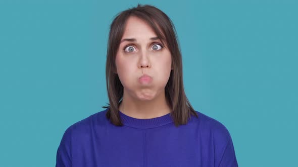 Studio Portrait of Funny Lady Fooling Around with Sticking Her Tongue Out and Twisting Finger on Her