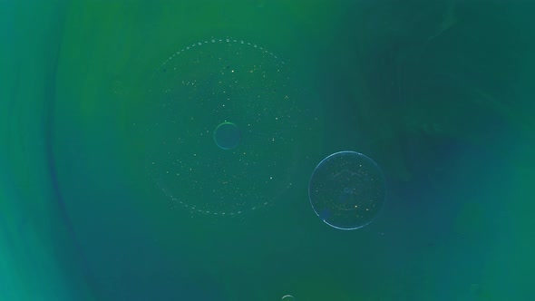 Moving Background Consisting of Blue and Green Particles of the Current Paint on a White Background