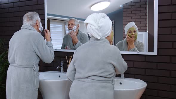 Old Senior Couple Man and Woman Doing Morning Hygiene Procedures and Looking Into a Mirror