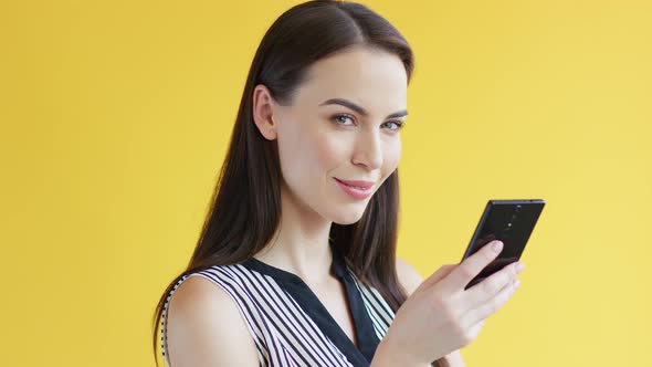 Gorgeous Female Using Smartphone Speaker