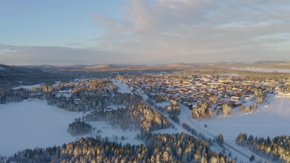 Scenic sunrise aerial view across snowy frozen Norbotten Lapland winter mountains landscape