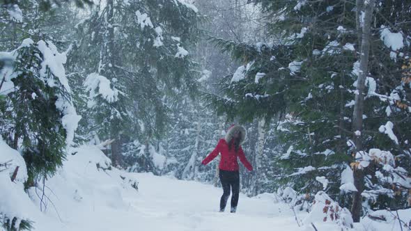 Young woman playing with snow alt