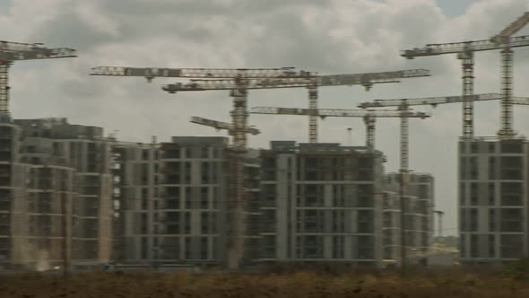 Large construction site with many cranes working over buildings