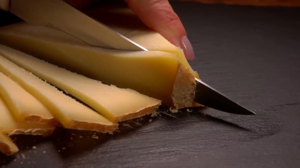 Hard Goat Cheese Is Cut Into Triangular Pieces
