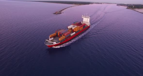 4K - To follow the cargo ship. Aerial view