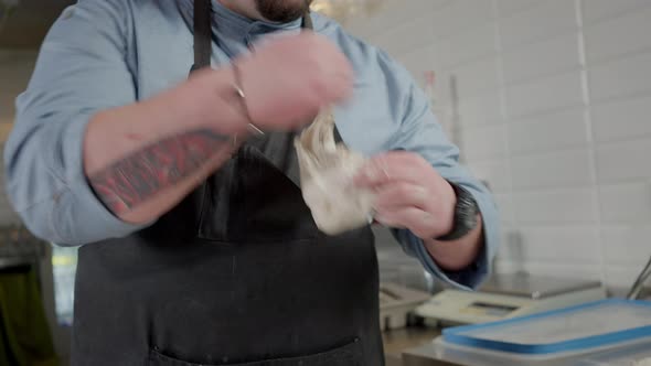 Live Camera Tattooed Professional Pizza Chef Forming Pinza Dough in Kitchen
