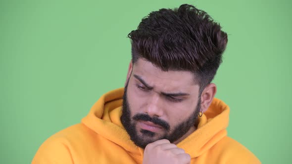 Face of Stressed Young Overweight Bearded Indian Man Thinking and Looking Down