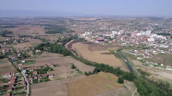 Distant view of farmland and small town in Kosovo