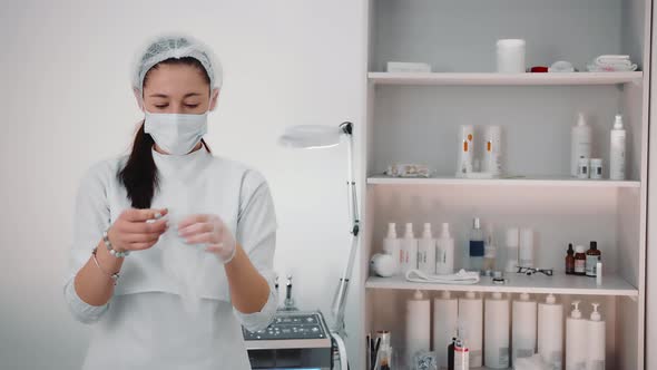 The Beautician Wears Transparent Protective Gloves