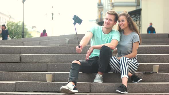 Young Trendy Couple Taking Selfie with Monopod