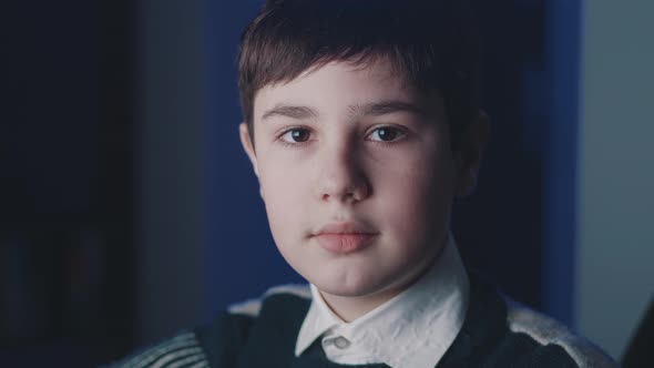 Closeup Portrait of Cute Boy 13 Years Old Looking at Camera While Sitting at Computer Laptop at Home