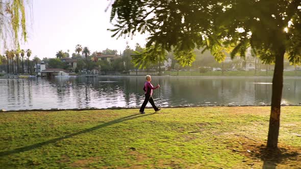 Senior Woman Working Out In The Park