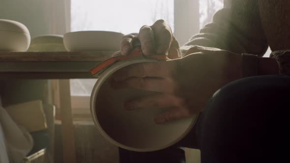 Man Is Polishing Wooden Bowl