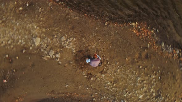 A Man Dances a Kind of Breakdancing in the Sand