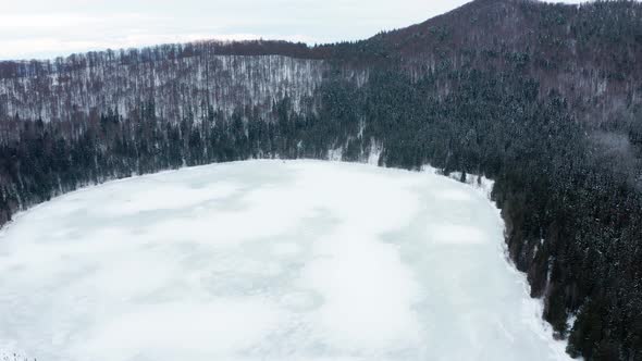 Volcanic Crater Lake Of Saint Anne Covered In Ice And Surrounded With Pine Forest At Winter In Hargh