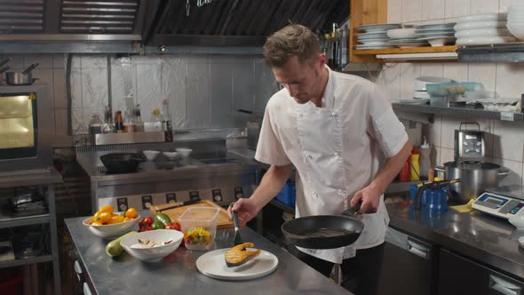 Chef Serving Salmon Steak On Plate