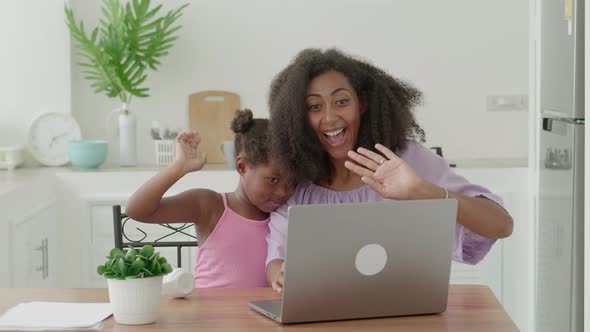 Mom and Daughter Make Video Call Communicates Online Using Laptop