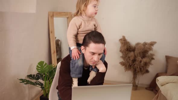 A Man Tries to Work Behind a Laptop at Home