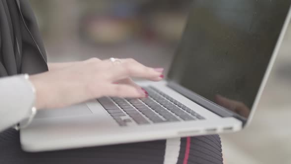 Close Up Shot Of Woman Typing On Keyboard Whilst Working Outside , In Slowmotion - Ungraded