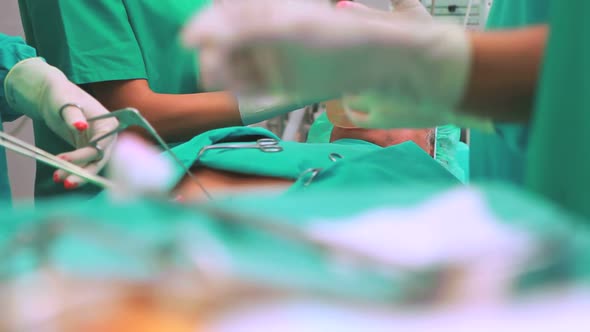 Close up of a surgical scissors next to a patient