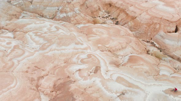 Drone Shot of Bicyclist Ride in Canyon Desert Mountains in Kazakhstan