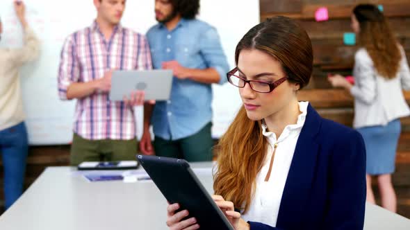 Business executive using digital tablet in meeting