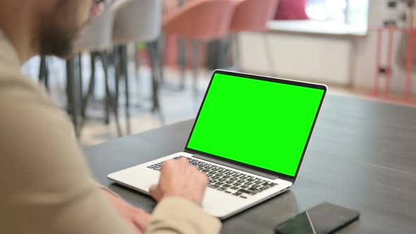 Man Using Laptop with Green Chroma Screen  Mock Up