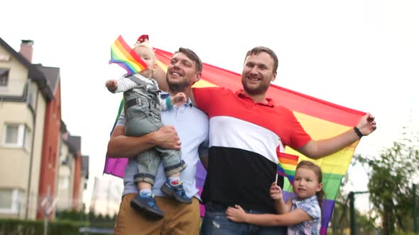 Happy Same-sex Family Near Their House with Flags and Two Children, a Boy and a Girl. Gay Rights