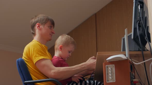 Man And Boy Playing Computer Games