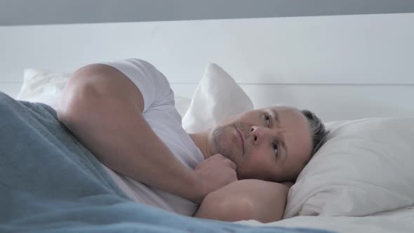 Pensive Gray Hair Man Thinking While Lying in Bed