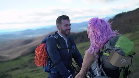 Slow motion shot of bridal couple face to face with hiking backpack