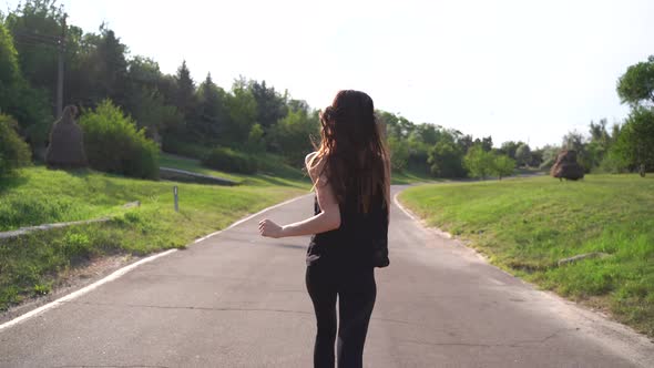 Back View Pretty Sporty Woman Jogging at Park in Sunrise Light