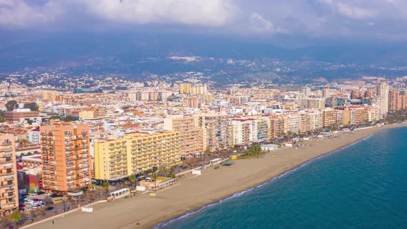 Aerial drone hyperlapse timelapse pull away of Fuengirola beachfront in Spain in winter