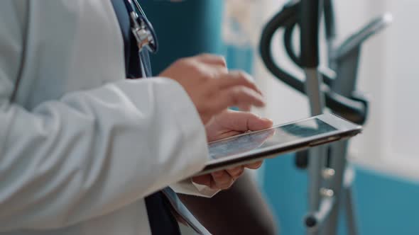 Male Doctor Using Digital Tablet at Checkup Appointment