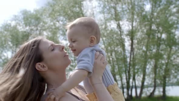 Laughing Mother Spinning Baby Boy