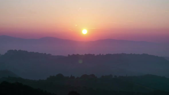Sunrise Time Lapse Over Hills and Mountains