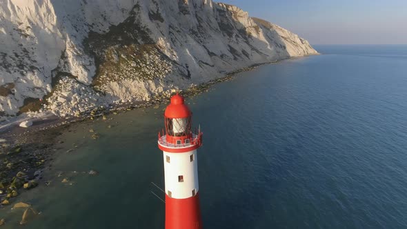 Rising Reveal of a Lighthouse in the Sea