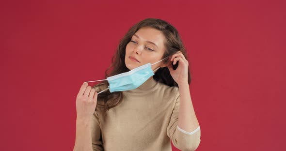 Caucasian Young Girl Beautiful Responsible Woman Putting on Blue Styryl Medical Mask on Face Showing