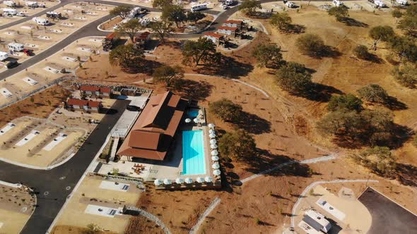 Aerial pan of an RV Resort Clubhouse and Pool.