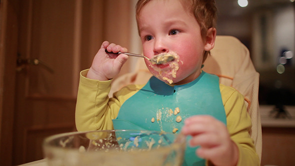 Two Year Old Boy Is Having Dinner 