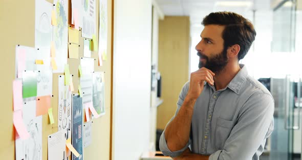 Male executive looking at bulletin board