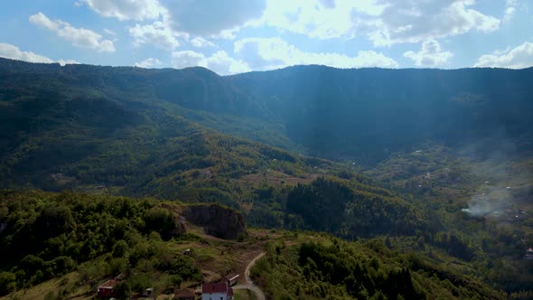 Steep green mountains, deep forest and mountain road, beautiful valley  