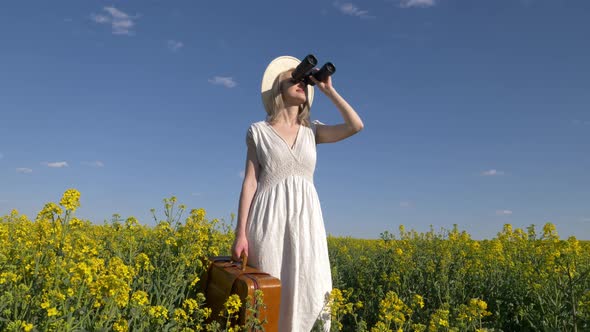 woman in white dress with suitcase and binocular