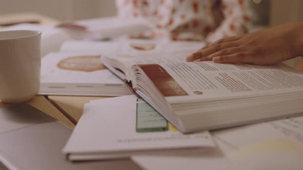 University Student At Table Of Books