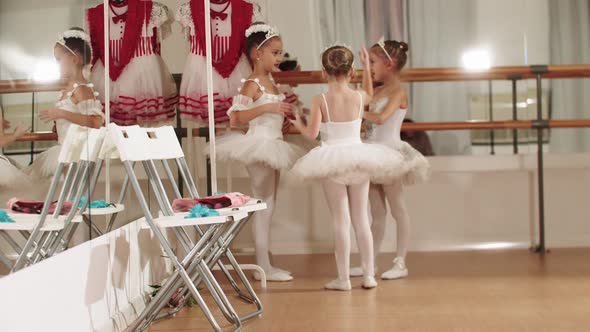 Three Little Ballet Girls Standing in the Corner of the Studio