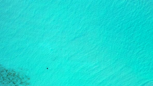 Aerial drone scenery of marine seashore beach trip by blue green sea and white sandy background of a