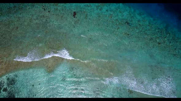 Aerial scenery of tranquil coastline beach trip by turquoise sea with bright sandy background of a d