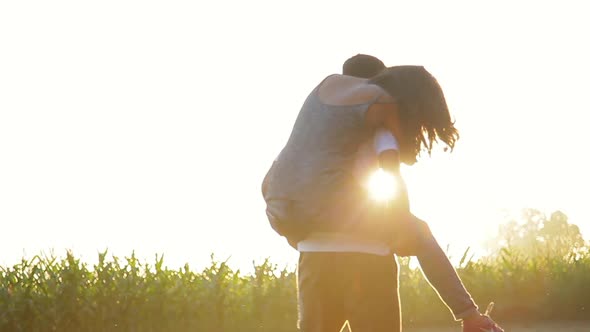 Young man giving his girlfriend a piggyback ride outdoors