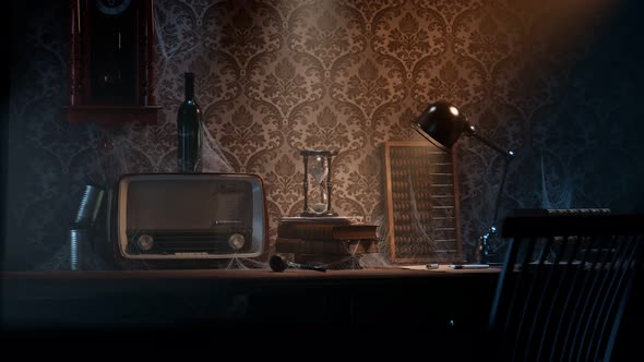 Antique hourglass on he vintage wooden desk in the old room. Abandoned office.