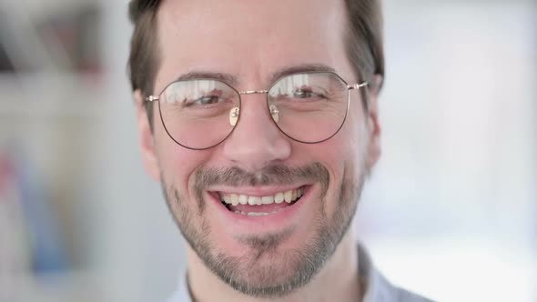 Face Close Up of Man in Glasses Smiling at the Camera